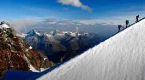 Three-climbers-edge-mountain-alps
