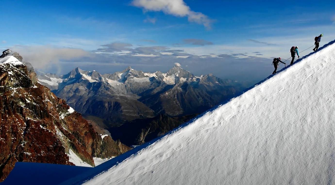 Three-climbers-edge-mountain-alps